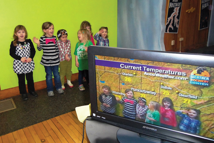 Young Visitors using the Green Screen at the Weather Discovery Center.